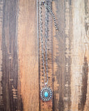 Hobbs Pendant Fashion Necklace with faux turquoise displayed on wood next to clear ruler.