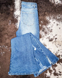 Jordan High Rise Dark Wash Distressed Flare Jeans displayed on cowhide.