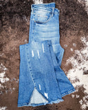 Jordan High Rise Dark Wash Distressed Flare Jeans displayed on cowhide.