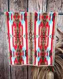 Ojo Caliente Towels displayed on a rod in front of wood background.