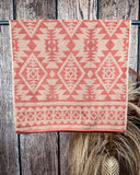 Navajo Adobe Towels displayed on rod in front of wood background.