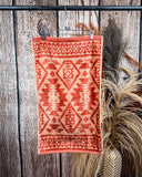 Navajo Adobe Towels displayed on rod in front of wood background.