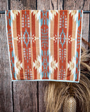 Pecos Towels displayed on rode in front of wood and wheat backdrop.