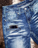 Close up of Turquoise Boot Stitch Bootcut Jeans displayed on cowhide.