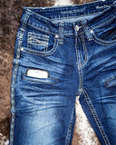 Close up of Honor Dark Trouser Jeans displayed on cowhide.