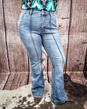 Steph High Waisted Trouser Flares being modeled on a women in front of wood background.