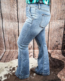 Steph High Waisted Trouser Flares being modeled on a women in front of wood background.