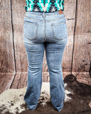 Steph High Waisted Trouser Flares being modeled on a women in front of wood background.
