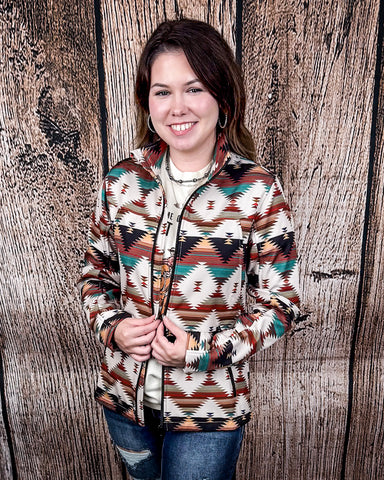 A model wearing the Southern Roots Soft Shell Jacket in a wooden backdrop.