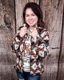 A model wearing the Southern Roots Soft Shell Jacket in a wooden backdrop.