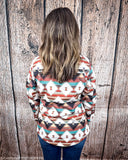 Back view of a model wearing the Southern Roots Soft Shell Jacket in a wooden backdrop.