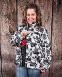 A model wearing the Life is a Rodeo Soft Shell Jacket with a wood backdrop.