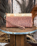 Back of the Angelstone Wallet in Brown and White on a wooden table with wheat in the back.