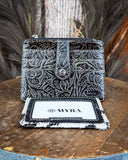 Inside of the Wonder Trail Card Holder in Black on a wood table with wheat in the back.