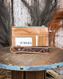 Back view of the Pride of Prickly Pears Card Holder on a wooden table with wheat in the back.