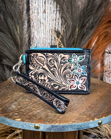 The Pride of Prickly Pears Card Holder in Black on a wooden table with wheat in the background.