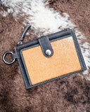 The Wind Rider Card Holder in Chocolate Brown displayed on cowhide.