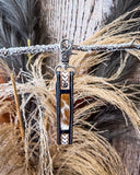 Decorative key fob with cowhide pattern on a textured background