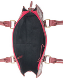 Inside of a handbag with brass accents on a white background