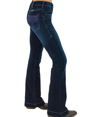 A person wearing dark blue western flare jeans with purple embroidered detailing on the back pocket, shown from the waist down against a white background.