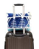 Blue and white patterned blanket on top of a suitcase