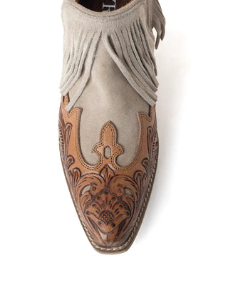 Beige ankle boot with brown floral embossing on a white background