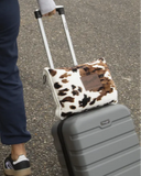 Wrangler Tri-Color Cowhide Travel Blanket being shown in use on a suitcase.