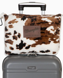 Wrangler Tri-Color Cowhide Travel Blanket shown in use on a suitcase in front of white backdrop.
