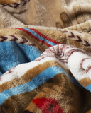 A close up of the Cactus Stripe Travel Blanket to show the pattern and fabric.