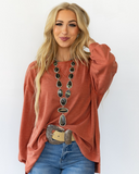 The Stillwater Tunic Top in color Rust being styled and modeled on women.