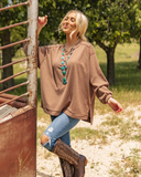 The Stillwater Tunic Top styled and modeled on a women in field.