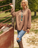 The Stillwater Tunic Top styled and modeled on a women in field.