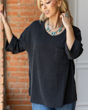 The Ellis Top in black being styled and modeled with jeans on women in studio setting.