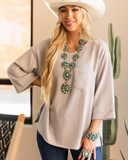 The Ellis Top in Pearl Grey being styled and modeled on women in studio setting.