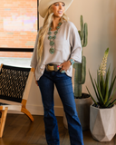 The Ellis Top in Pearl Grey being styled and modeled on women in studio setting.