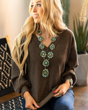 The Hadley Top in mocha being styled and worn by a women in studio setting.