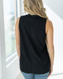 he Lanie Tank in black being styled and modeled by a women in studio setting.