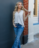 The Lanie Tank in Oatmeal being styled and modeled on women in front of wall.