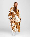 Person wearing a brown and white patterned blanket against a white background