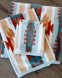 Pecos Towels folded and displayed on wood background.