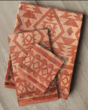 Navajo Adobe Towels folded and displayed on wood background.