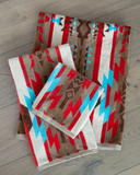 Ojo Caliente Towels folded displayed on wood flooring
