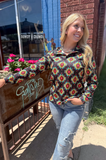 The Palmer Pullover being styled and modeled by women outside.