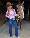 Woman wearing Tuff Sport Bootcut Jeans standing next to a horse in a stable.