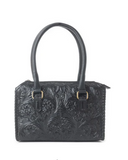 Black tooled handbag on a white background