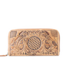 Handcrafted leather wallet with intricate patterns on a white background