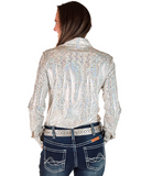 Woman wearing a sparkly silver blouse and jeans on a white background