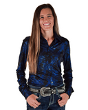 Woman wearing a blue patterned shirt with a silver belt on a white background
