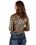 Woman wearing a patterned blouse and jeans on a white background