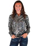 Woman wearing a patterned shirt and jeans on a white background